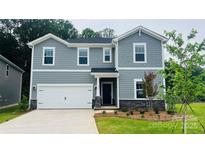 Charming two-story home with light gray siding, a two-car garage, and a well-maintained lawn at 116 Obadiah Ct, Mooresville, NC 28115