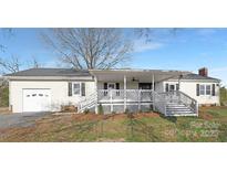 Charming one story home with a covered porch and an attached garage at 12491 Oak Grove Rd, Stanley, NC 28163