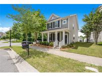 Charming two-story home with a welcoming front porch and manicured lawn, perfect for suburban living at 13107 Heath Grove Dr, Huntersville, NC 28078