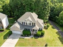 Aerial view of a two-story home with landscaped lawn and mature trees at 161 Dairy Farm Rd, Mooresville, NC 28115
