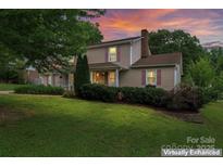 Charming two-story home with lush front lawn and inviting front porch at 1724 Windy Rush Ln, Gastonia, NC 28054