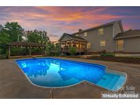 Backyard with a sparkling pool, a charming gazebo, and a lovely outdoor patio at 1724 Windy Rush Ln, Gastonia, NC 28054