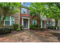 Charming brick townhome with well-maintained landscaping and a welcoming front entrance at 18460 W Catawba Ave, Cornelius, NC 28031