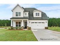 Charming two-story home featuring a two-car garage, landscaped front yard and shingle and board and batten siding at 20396 Queens St, Cornelius, NC 28031