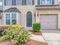 Inviting front door with an arched transom window, neutral siding and manicured landscaping at 2331 Whitford Ln, Charlotte, NC 28210