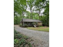 Charming single-story home featuring a screened front porch and mature landscaping at 3000 Low Gap Rd, Waxhaw, NC 28173