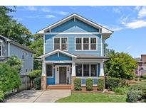Charming blue two-story home featuring a welcoming front porch and well-maintained landscaping at 331 Solomon St, Charlotte, NC 28216