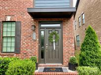 Inviting brick home featuring a stylish front door with a decorative wreath and charming curb appeal at 344 Linestowe Dr, Belmont, NC 28012