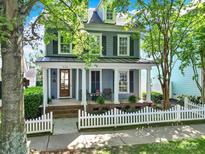 Charming two-story home with a welcoming front porch, white picket fence and beautiful trees at 436 Third Baxter St, Fort Mill, SC 29708