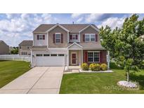 Charming two-story home featuring a well-manicured lawn and a two-car garage at 5003 Singletree Ln, Indian Trail, NC 28079