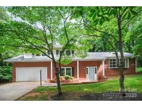 Inviting red brick home with well-manicured lawn and a two-car garage for added convenience at 506 Richards Dr, Shelby, NC 28150