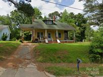 Charming, classic home with a covered front porch and mature trees in a desirable neighborhood at 607 Lee Ave, Wadesboro, NC 28170