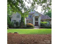 Charming two-story brick home with manicured lawn and lush landscaping at 6795 Montgomery Rd, Lake Wylie, SC 29710