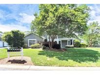 Charming home featuring a well-manicured lawn, mature tree, and appealing curb appeal in a tranquil setting at 7123 Meeting St, Charlotte, NC 28210