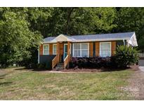 Charming exterior of a single-story home with a well-manicured lawn and inviting curb appeal at 728 Morningside Dr, Mount Holly, NC 28120