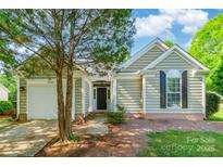 Charming home featuring attached garage, neutral siding, and manicured landscaping at 8339 Hornwood Ct, Charlotte, NC 28215