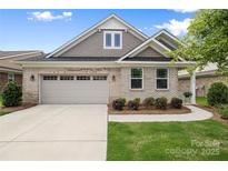 Charming single-story home featuring a brick facade, attached garage, and well-maintained landscaping at 9109 Liberty Hill Dr, Mint Hill, NC 28227