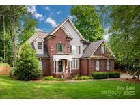 Charming brick home featuring a manicured lawn and inviting front porch perfect for relaxing at 117 Lake Hills Dr, Mooresville, NC 28117