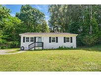 Charming one-story home features a well-maintained lawn, complemented by lush greenery and a welcoming front porch at 1215 Cardinal Dr # 9, Gastonia, NC 28052