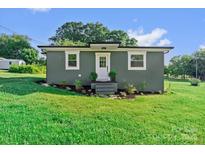 Charming home featuring a painted exterior, a well-manicured lawn, and tasteful landscaping at 134 Snowbird Loop, Statesville, NC 28625