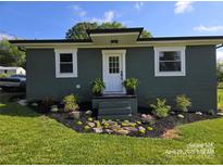 Charming single-story home boasts a well-manicured lawn, fresh landscaping, and a freshly painted exterior at 134 Snowbird Loop, Statesville, NC 28625