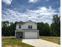 Two-story home featuring white siding and stone accents, complemented by an attached two-car garage and newly poured driveway at 139 Dove Creek Trl, Statesville, NC 28625