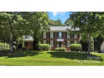 Traditional brick home featuring black shutters, manicured landscaping, and a lush front lawn at 147 35Th Ne Ave, Hickory, NC 28601