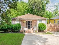 Charming single-story home featuring a cozy porch, well-maintained landscaping, and a welcoming entrance at 1817 Rush Wind Dr, Charlotte, NC 28206