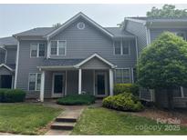 Charming gray townhouse with well-manicured lawn and a welcoming walkway at 2958 Iron Gate Ln, Charlotte, NC 28212