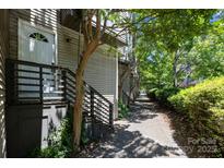 View of the front of the townhouse with a lovely walkway at 415 W 7Th St # H, Charlotte, NC 28202