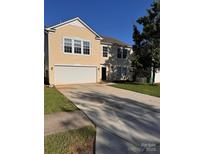 Charming two-story home with a two-car garage and a well-maintained lawn on a sunny day at 4521 Palustris Ct, Charlotte, NC 28269