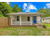 Charming home featuring a covered porch with a blue front door at 485 Lincoln St, Cramerton, NC 28032