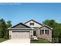 Charming two-story home featuring a stone facade, attached garage, and well-manicured lawn at 577 Nesbe St # 2222, Lancaster, SC 29720
