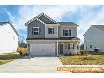 Charming two-story home showcasing traditional architecture and a well-manicured front lawn at 6336 Busch Ave, Midland, NC 28107
