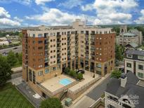 Stunning aerial view of multi-story condo building with pool and manicured landscaping at 715 N Church St, Charlotte, NC 28202