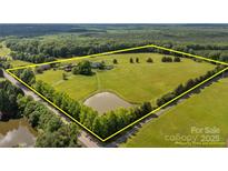 Expansive acreage featuring a serene pond and mature trees, ideal for country living at 18070 Old Beatty Ford Rd, Gold Hill, NC 28071