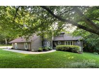 Charming home with wood siding, manicured lawn, and mature trees offering curb appeal at 2045 10Th Street Nw Ln, Hickory, NC 28601