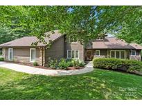 Charming two-story home features a manicured lawn, stone accents, and lush landscaping at 2045 10Th Street Nw Ln, Hickory, NC 28601