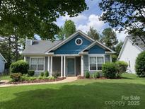 Charming single-story home featuring a well-manicured lawn and inviting front entrance, perfect for a cozy lifestyle at 317 Cedarcroft Dr, Mooresville, NC 28115
