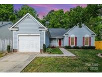 Charming single-Gathering home featuring a one car garage, red shutters and door, and a well-manicured lawn at 3505 Frostmoor Pl, Charlotte, NC 28269