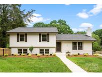 Charming two-story home featuring a manicured lawn, fresh landscaping, and a classic white facade at 3661 Annlin Ave, Charlotte, NC 28209