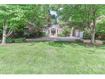 Traditional brick home with lush green lawn, mature trees, and circular driveway at 625 Saint Andrews Rd, Statesville, NC 28625