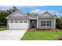 Charming single-story home with stone accents, gray siding, white garage door, and well-manicured lawn at 7121 Jerimoth Dr, Charlotte, NC 28215