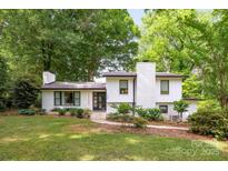 Charming white-brick home with well-manicured lawn and mature trees, offering great curb appeal at 7123 Linda Lake Dr, Charlotte, NC 28215