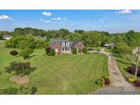 Expansive front yard, classic brick home, and private driveway highlight this property at 814 Settlers Dr, Cherryville, NC 28021