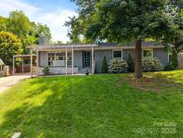 Charming one-story home with a well-maintained lawn and mature trees offering shade at 917 Dent Ct, Charlotte, NC 28210