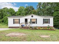 Charming single-story home with white siding, black shutters, and a cozy front porch at 103 Palace Pt, Kings Mountain, NC 28086