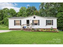 Charming single-story home with white siding, black shutters, and a lush green lawn at 103 Palace Pt, Kings Mountain, NC 28086