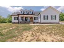 Charming two-story farmhouse style home featuring a welcoming front porch and dormer windows at 1134 Fincher Rd, Fort Lawn, SC 29714