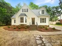 Charming home with a classic design, lush landscaping, and welcoming entrance, offering great curb appeal at 1212 Beechdale Dr, Charlotte, NC 28212